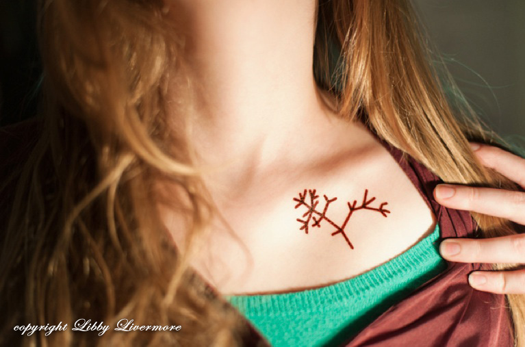 Photograph of a treeoflife tattoo on a girl's neck Taken on Darwin Day 