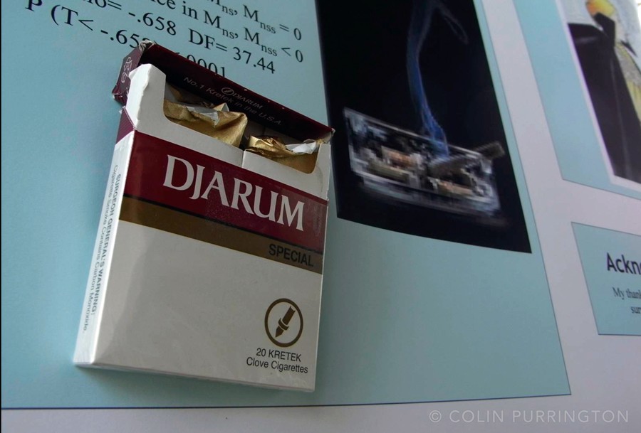 Box of cigarettes attached to academic poster