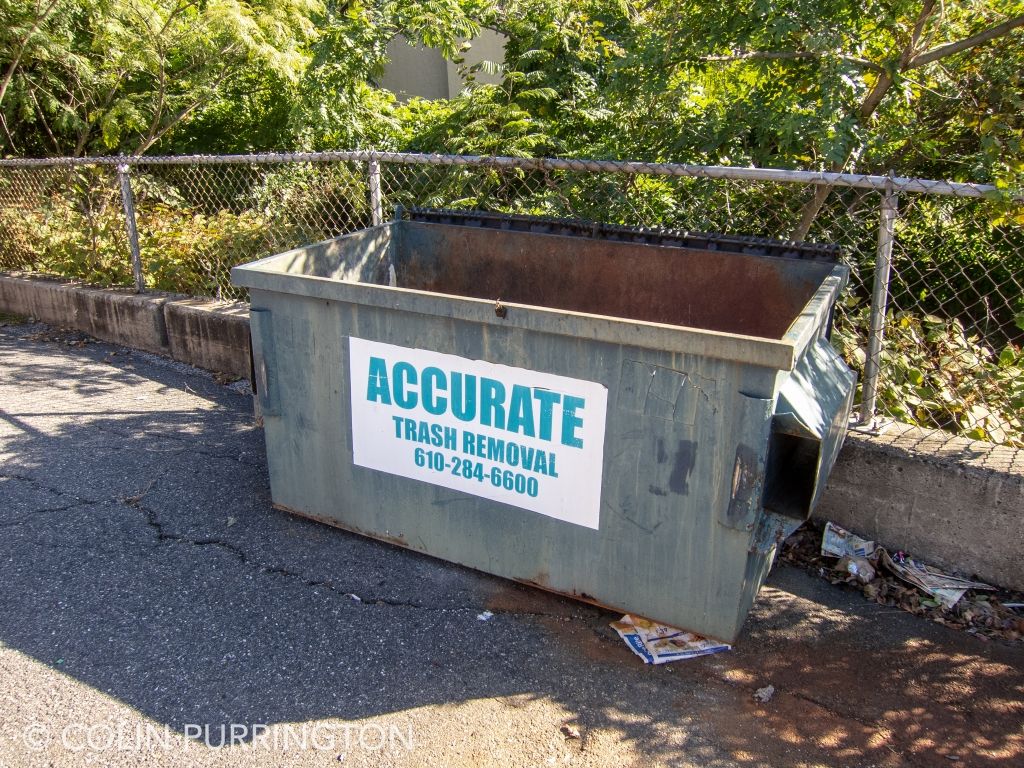 Uncovered dumpster with stagnant water