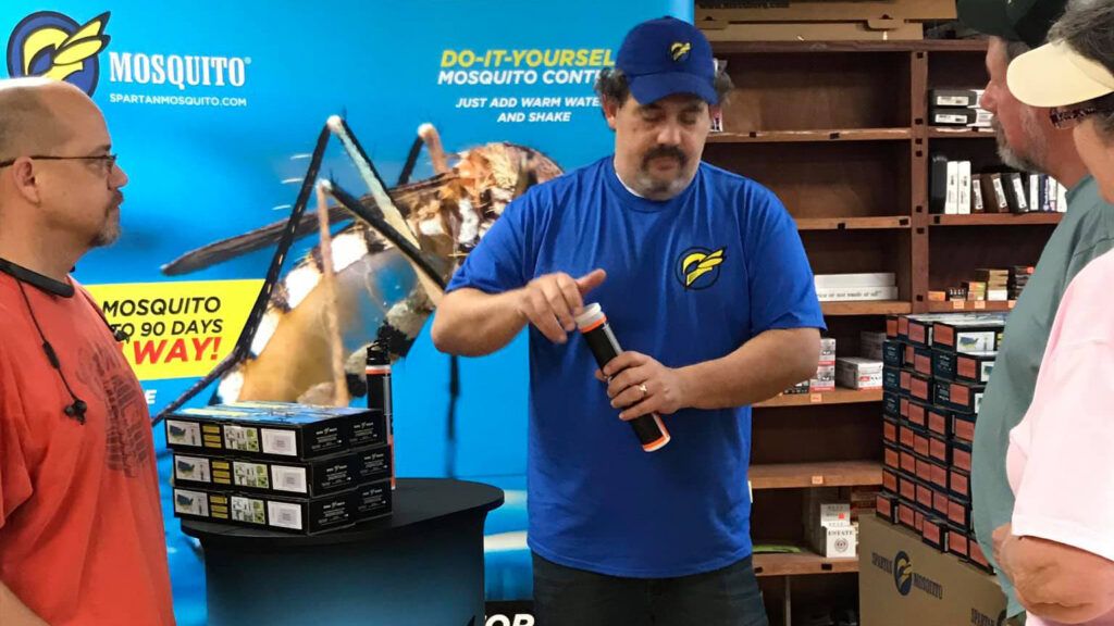 Chris Bonner and Jeremy Hirsch at a feed store demonstrating their invention, the Spartan Mosquito Eradicator.