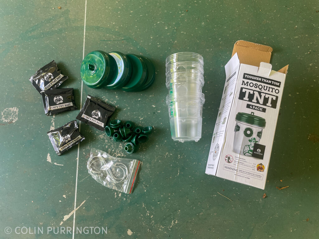 Mosquito TNT kit showing containers, lids, bait packets, and s-hooks.