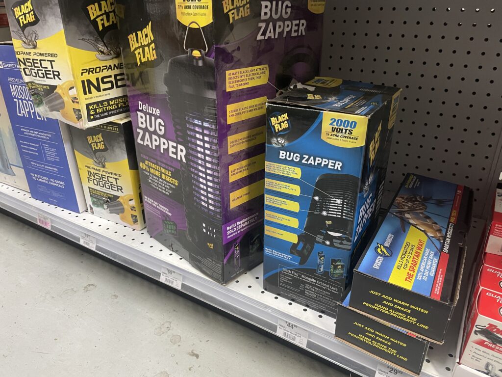 Shelf with boxes of bug zappers and other scam mosquito-control devices.